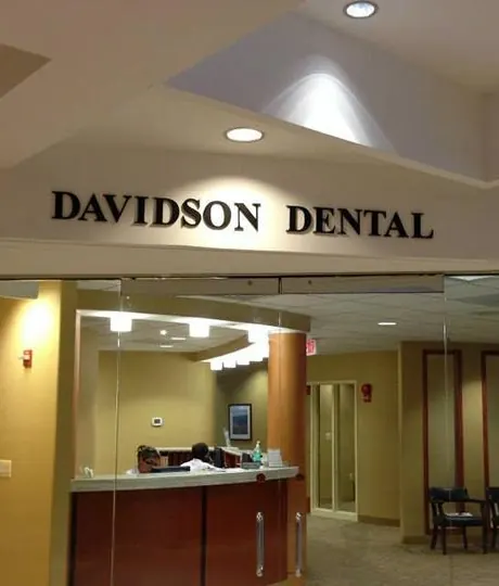 The glass entrance to Davidson Dental Associates, with the front desk behind it.